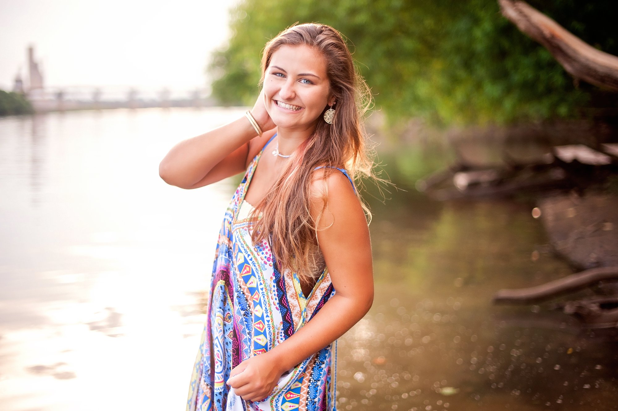 Senior pictures in the river at sunset with gorgeous back light