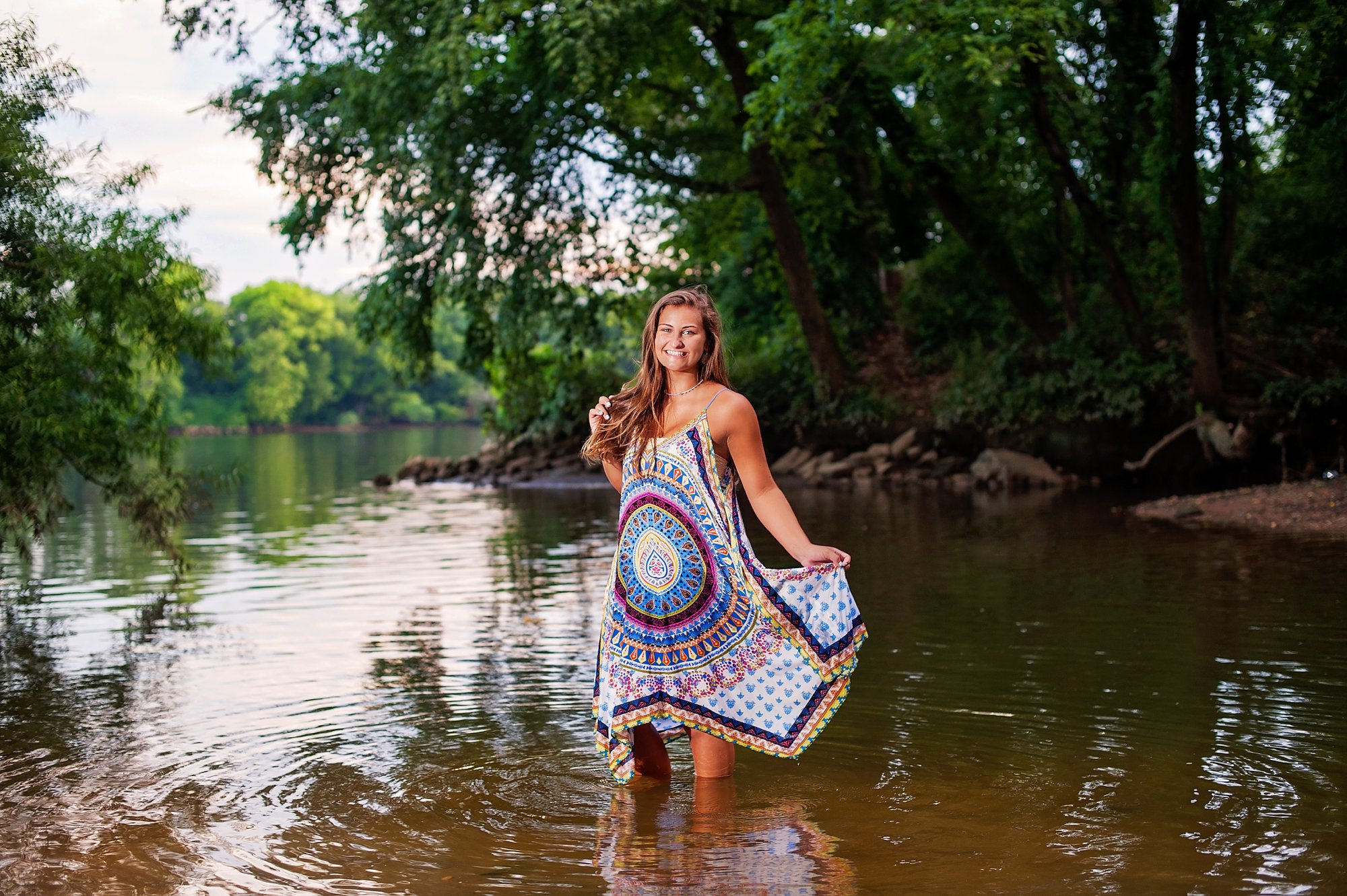 Beautiful senior girl portrait in river with off camera flash