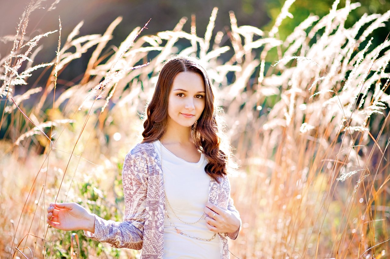 Senior girl portrait session with tall weeds and backlight