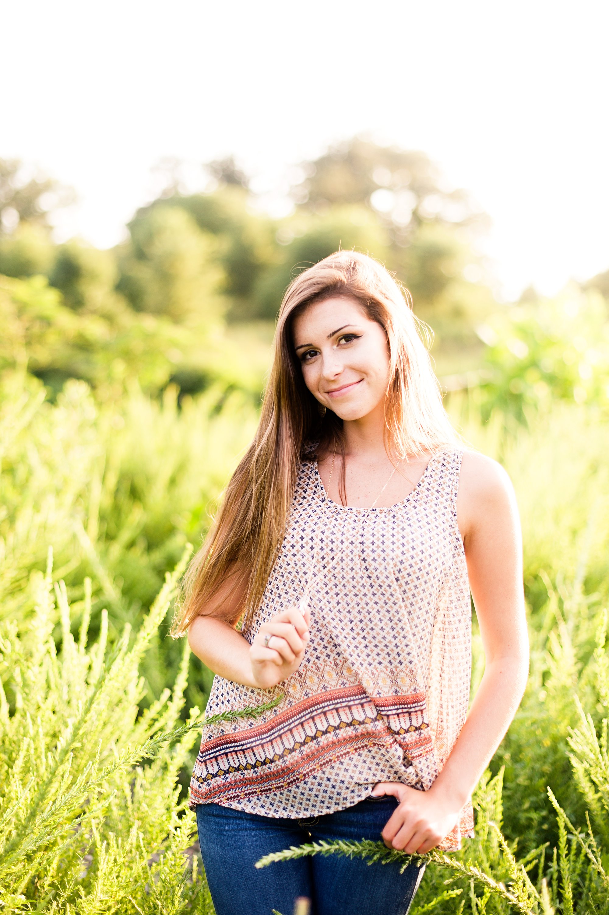 richmond senior girl pictures in field of tall grass at sunset with gorgeous back lights
