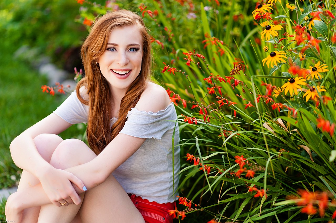 high school senior portraits with red head and flowers