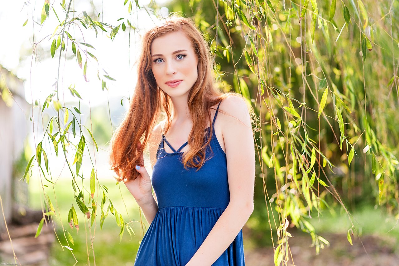 red head senior in weeping willow tree